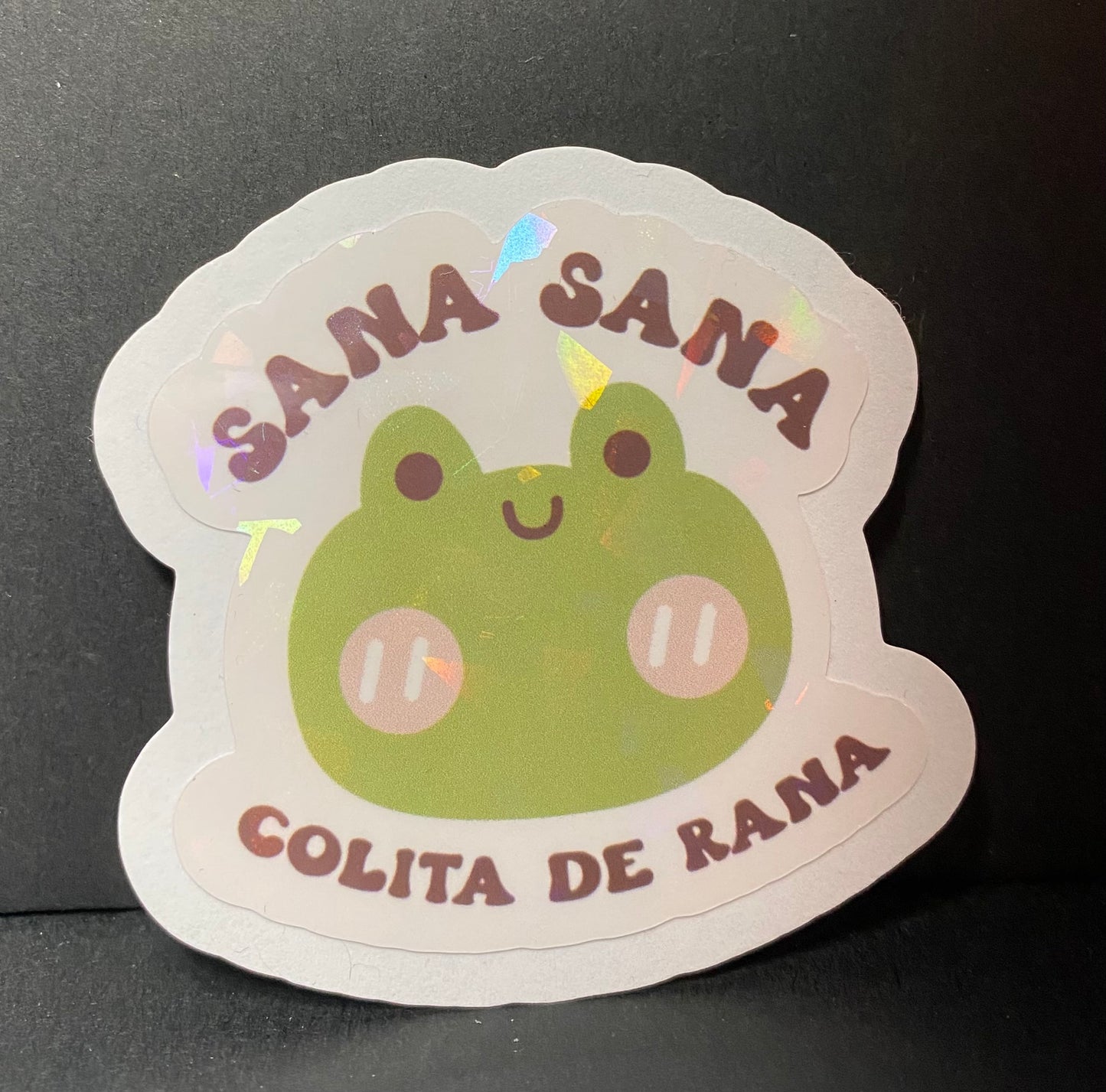 “Sana Sana colita de Rana” holographic sticker